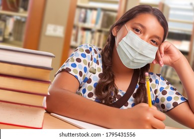 Hispanic Girl Student Wearing Face Mask Studying In Library.