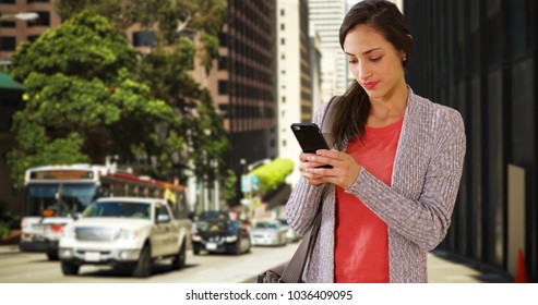 A Hispanic Girl Texts On A San Francisco Street Corner