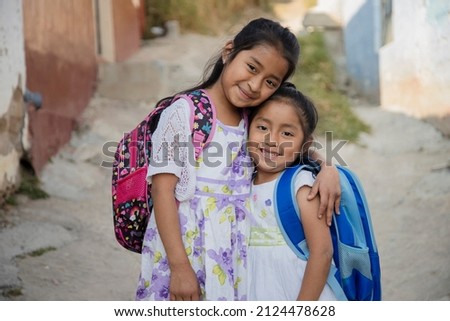 Hispanic girls ready to go to school in rural area - Latin sisters on their way to school - Happy Mayan girls in the village