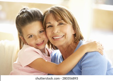 Hispanic Grandmother And Granddaughter Relaxing At Home