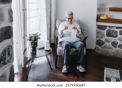 Hispanic Grandmother Knitting At Home In Mexico Latin America