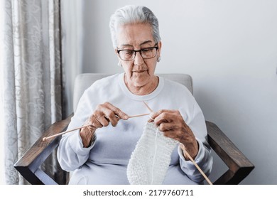 Hispanic Grandmother Knitting Or Weaving At Home In Mexico Latin America