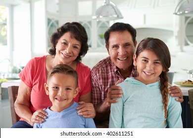 Hispanic Grandparents At Home With Grandchildren