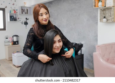 Hispanic Hairstylist Showing Her Client Her New Hair Style - Work Is Done - Makeover At The Hairdresser - Enterprising Professional Woman