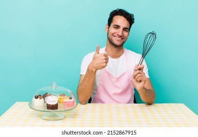 Hispanic Handsome Man Feeling Proud,smiling Positively With Thumbs Up. Home Made Cakes Cocnept