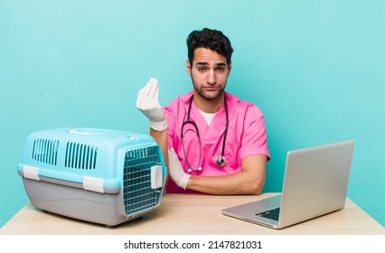 Hispanic Handsome Man Making Capice Or Money Gesture, Telling You To Pay. Veterinarian Concept