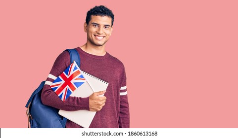 Hispanic handsome young man exchange student holding uk flag looking positive and happy standing and smiling with a confident smile showing teeth  - Powered by Shutterstock