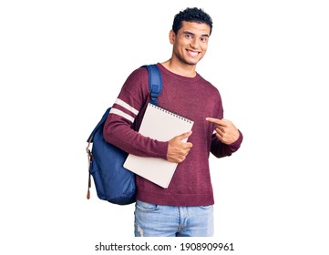 Hispanic Handsome Young Man Wearing Student Backpack And Notebook Smiling Happy Pointing With Hand And Finger 