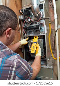 Hispanic Handyman Repairman Conducting Residential HVAC Repair