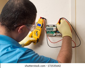 Hispanic Handyman Repairman Conducting Residential HVAC Repair