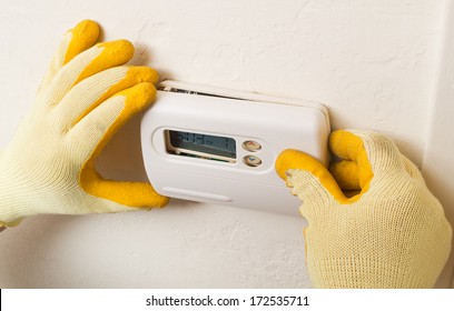 Hispanic Handyman Repairman Conducting Residential HVAC Repair