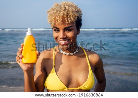 hispanic latin beautiful female use spf block cream skin seashells on the neck on sea beach