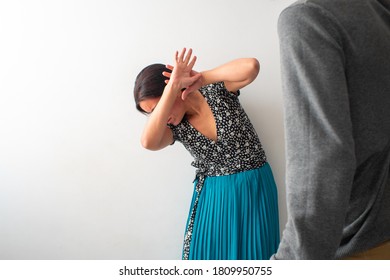 Hispanic / Latin Woman Covers her Face with Fear of Being Hit