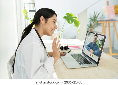 Hispanic Latina Woman Doctor Telecommuting From Home By Video Call