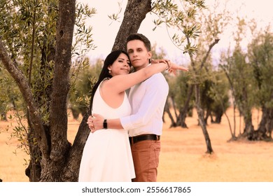 Hispanic Latino couple having a romantic moment in a dry autumn field of olive trees - Powered by Shutterstock