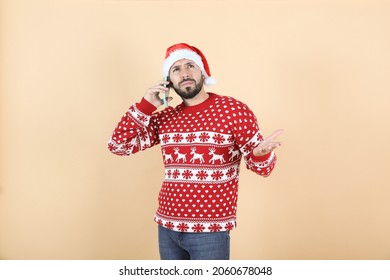 Hispanic Latino Man With Christmas Hat Using Mobile Phone