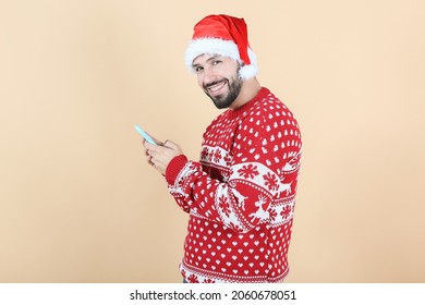 Hispanic Latino Man With Christmas Hat Using Mobile Phone