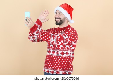 Hispanic Latino Man, With Christmas Hat Video Call By Mobile Phone