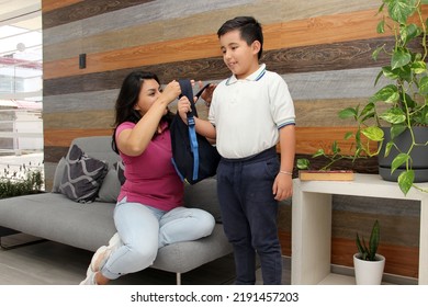 Hispanic Latino Mom And Son Prepare For Back To School In Uniform And Backpack Say Goodbye In The Morning