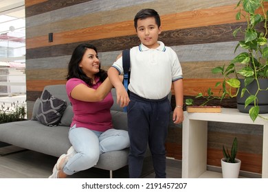 Hispanic Latino Mom And Son Prepare For Back To School In Uniform And Backpack Say Goodbye In The Morning