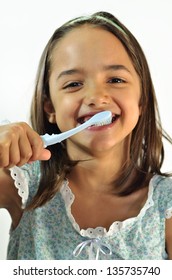 Hispanic Little Girl Brushing Her Teeth