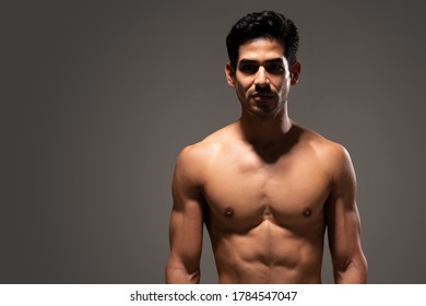 Hispanic Male Athlete With Ripped Body Isolated Over Gray Background