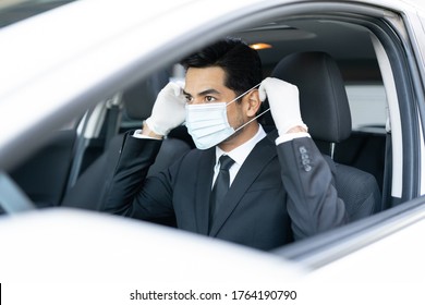 Hispanic Male Driver Wearing Mask In Car During Coronavirus Outbreak