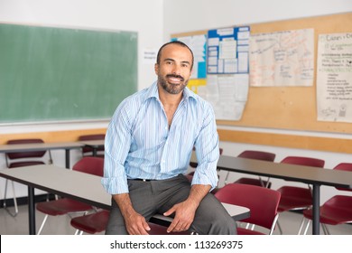 Hispanic Male Teacher In His Classroom