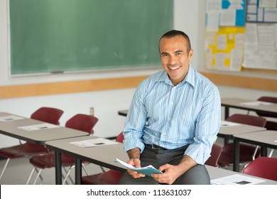 Hispanic Male Teacher in his classroom