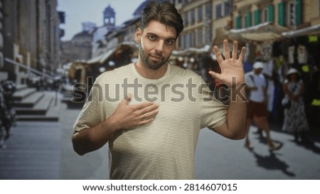Hispanic man with beard placing hand on chest and raising other palm in a pledge gesture amid a busy outdoor market street; apologetic sincerity.