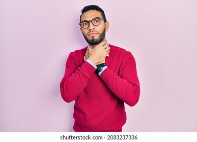 Hispanic man with beard wearing business shirt and glasses shouting suffocate because painful strangle. health problem. asphyxiate and suicide concept. 