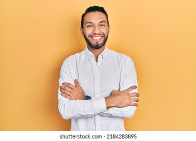 Hispanic man with beard wearing business shirt happy face smiling with crossed arms looking at the camera. positive person.  - Powered by Shutterstock