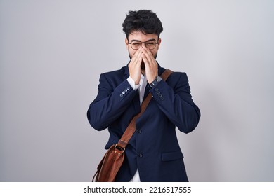 Hispanic Man With Beard Wearing Business Clothes Laughing And Embarrassed Giggle Covering Mouth With Hands, Gossip And Scandal Concept 