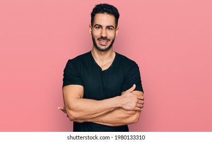 Hispanic Man With Beard Wearing Casual Black T Shirt Happy Face Smiling With Crossed Arms Looking At The Camera. Positive Person. 