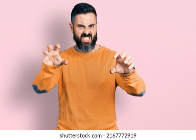 Hispanic Man With Beard Wearing Casual Winter Sweater Smiling Funny Doing Claw Gesture As Cat, Aggressive And Sexy Expression 