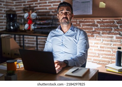 Hispanic Man With Beard Working At The Office At Night Depressed And Worry For Distress, Crying Angry And Afraid. Sad Expression. 