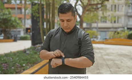 Hispanic man checking smartwatch in city park - Powered by Shutterstock