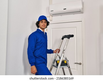 Hispanic Man With Curly Hair Working At Home Renovation Thinking Attitude And Sober Expression Looking Self Confident 