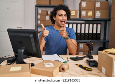 Hispanic Man With Curly Hair Working At Small Business Ecommerce Pointing Fingers To Camera With Happy And Funny Face. Good Energy And Vibes. 