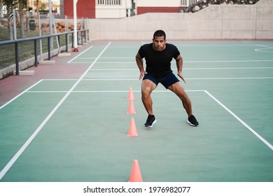 Hispanic Man Doing Speed And Agility Cone Drills Workout Session Outdoors - Focus On Man Face