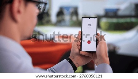 Hispanic Man Quickly Dialing Emergency Number On Mobile Phone After Car Accident