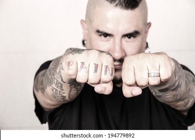 A Hispanic Man Showing Its Tattoo On The Fist.