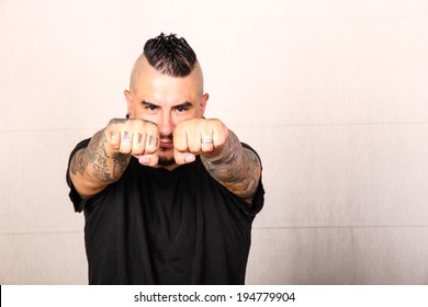 A Hispanic Man Showing Its Tattoo On The Fist.