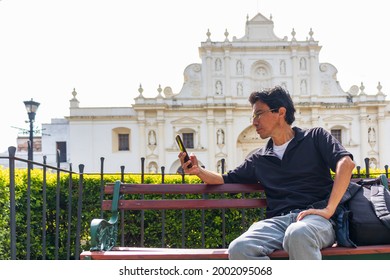 Hispanic man sitting in a park bench in antigua guatemala central park - Shutterstock ID 2002095068