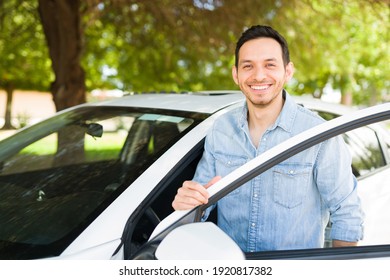 Hispanic Man Smiling And Getting Into The Driver's Seat Of His Car. Male Taxi Driver About To Pick A Costumer Of A Ride Sharing App