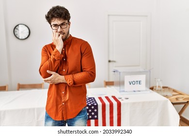 Hispanic Man Standing By Election Room Looking Stressed And Nervous With Hands On Mouth Biting Nails. Anxiety Problem. 
