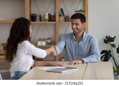 Hispanic man, successful job seeker shake hand woman HR manager after being accepted on vacant place position in company. Business partner handshake, come to agreement, formal greeting, hiring concept - Powered by Shutterstock