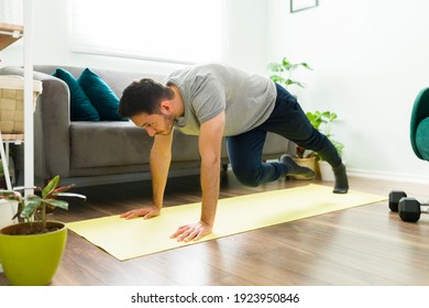 Hispanic Man Training With A High Intensity Interval Workout. Handsome Young Man Doing Mountain Climbers At Home