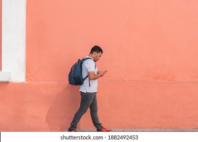 Hispanic man walking down the street