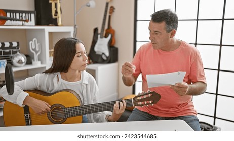 Hispanic man and woman musicians delight in a classic guitar melody at a music studio, concentrating in the serene ambience filled with the essence of spanish classical tunes - Powered by Shutterstock